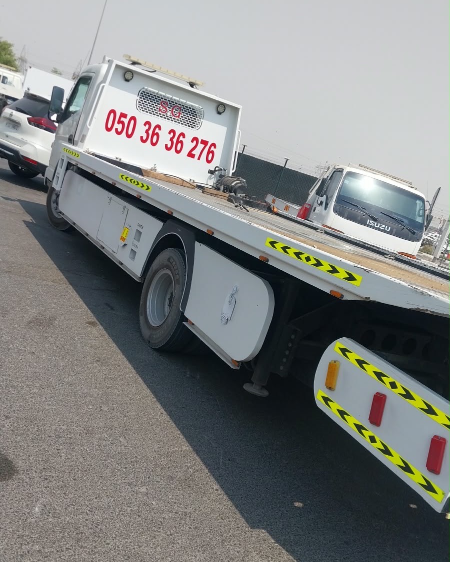 Side view of the flatbed recovery truck used for car towing in Ajman and Sharjah